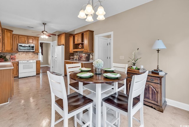 6161 Inman Cir, Conway, SC 29526 - dining space featuring a ceiling fan, a chandelier, and baseboards