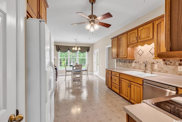 6161 Inman Cir, Conway, SC 29526 - kitchen featuring a sink, white refrigerator with ice dispenser, dishwasher, and brown cabinetry