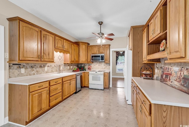 6161 Inman Cir, Conway, SC 29526 - kitchen with appliances with stainless steel finishes, a sink, a ceiling fan, backsplash, and light countertops
