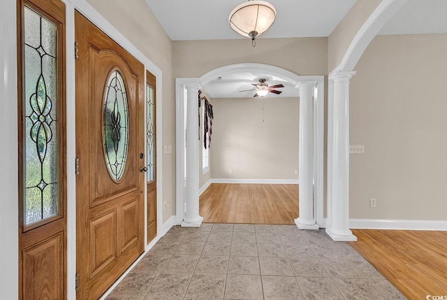 6161 Inman Cir, Conway, SC 29526 - foyer entrance featuring ornate columns, arched walkways, ceiling fan, light tile patterned flooring, and baseboards