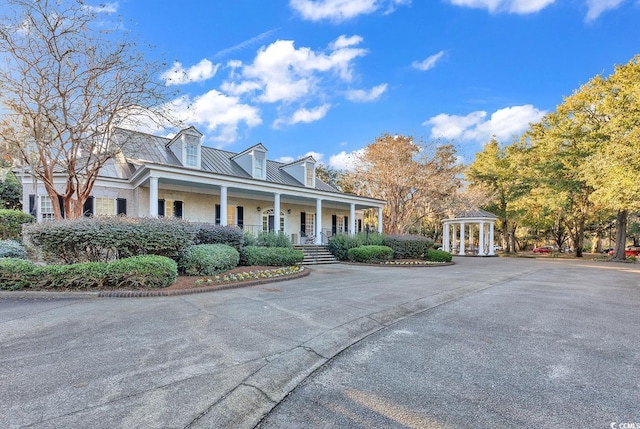 383 Oatland Lake Rd, Pawleys Island, SC 29585 - cape cod-style house with covered porch, a gazebo, and metal roof