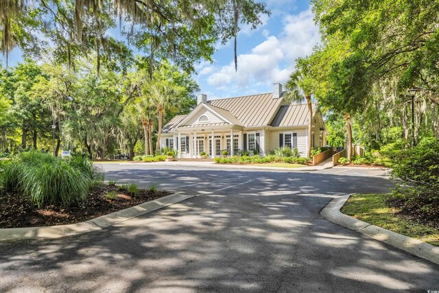 383 Oatland Lake Rd, Pawleys Island, SC 29585 - view of front facade with a chimney, a standing seam roof, and metal roof