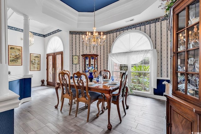 383 Oatland Lake Rd, Pawleys Island, SC 29585 - dining area with wallpapered walls, a chandelier, a tray ceiling, wood finished floors, and crown molding