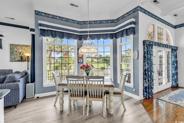 383 Oatland Lake Rd, Pawleys Island, SC 29585 - dining room featuring ornamental molding, wood finished floors, baseboards, and a chandelier