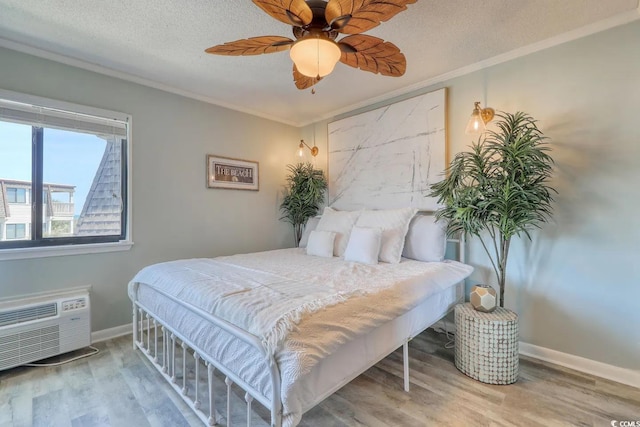 5601 N Ocean Blvd Unit A-307, Myrtle Beach, SC 29577 - bedroom with wood finished floors, crown molding, baseboards, a wall unit AC, and ceiling fan