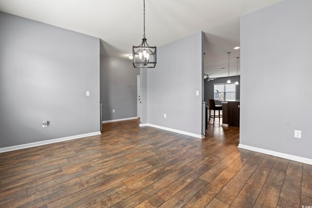 4115 Alvina Way, Myrtle Beach, SC 29579 - unfurnished room with a chandelier, dark wood finished floors, baseboards, and recessed lighting