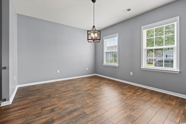 4115 Alvina Way, Myrtle Beach, SC 29579 - empty room featuring a chandelier, dark wood-type flooring, and baseboards