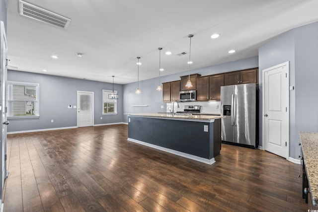4115 Alvina Way, Myrtle Beach, SC 29579 - kitchen with stainless steel appliances, dark brown cabinetry, plenty of natural light, decorative light fixtures, and recessed lighting