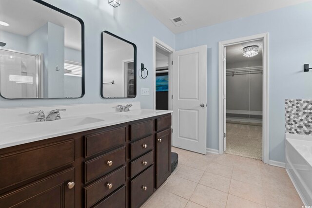 4115 Alvina Way, Myrtle Beach, SC 29579 - bathroom with a spacious closet, a bath, a stall shower, double vanity, and tile patterned floors