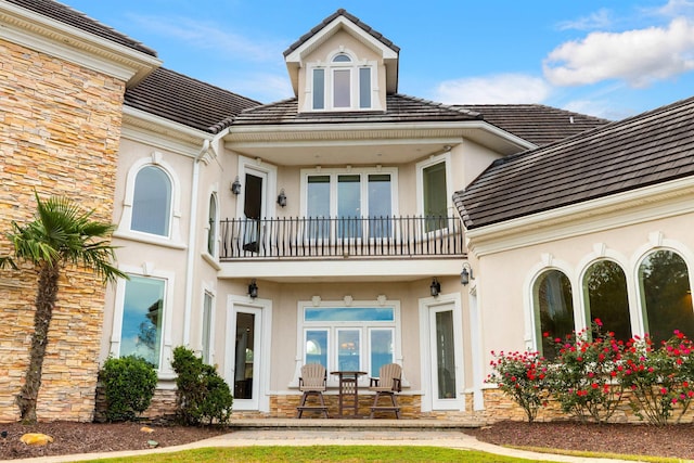 2715 Ships Wheel Dr, North Myrtle Beach, SC 29582 - back of house with a balcony, stucco siding, and stone siding