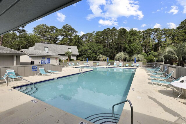 88 Salt Marsh Cir Unit 22F, Pawleys Island, SC 29585 - community pool featuring a patio area and view of scattered trees