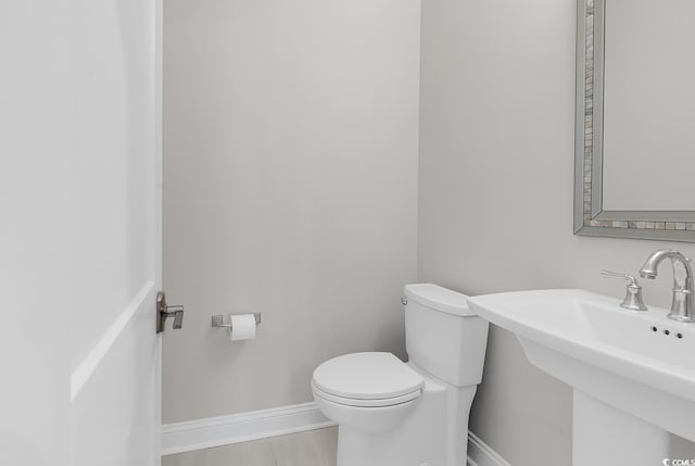 133 Deloach Trl, Pawleys Island, SC 29585 - bathroom with toilet, baseboards, and a sink