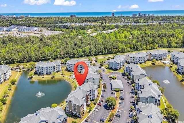 4820 Magnolia Lake Dr Unit 305, Myrtle Beach, SC 29577 - bird's eye view of a large body of water, apartment complex / building, and a tree filled landscape
