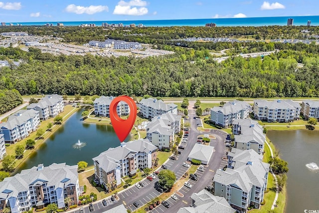 4820 Magnolia Lake Dr Unit 305, Myrtle Beach, SC 29577 - drone / aerial view of a nearby body of water, a tree filled landscape, and apartment complex / building