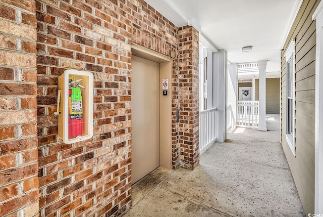 4820 Magnolia Lake Dr Unit 305, Myrtle Beach, SC 29577 - doorway to property with brick siding, a porch, and elevator