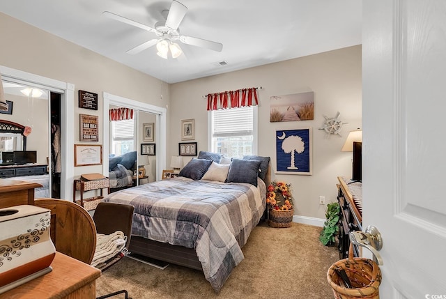 4820 Magnolia Lake Dr Unit 305, Myrtle Beach, SC 29577 - carpeted bedroom featuring multiple windows, baseboards, ceiling fan, and multiple closets