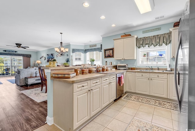 4820 Magnolia Lake Dr Unit 305, Myrtle Beach, SC 29577 - kitchen featuring stainless steel appliances, a peninsula, ornamental molding, recessed lighting, and open floor plan