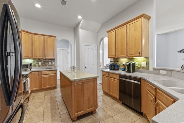 29 Saltwind Loop, Murrells Inlet, SC 29576 - kitchen featuring stainless steel appliances, arched walkways, a sink, backsplash, and light countertops