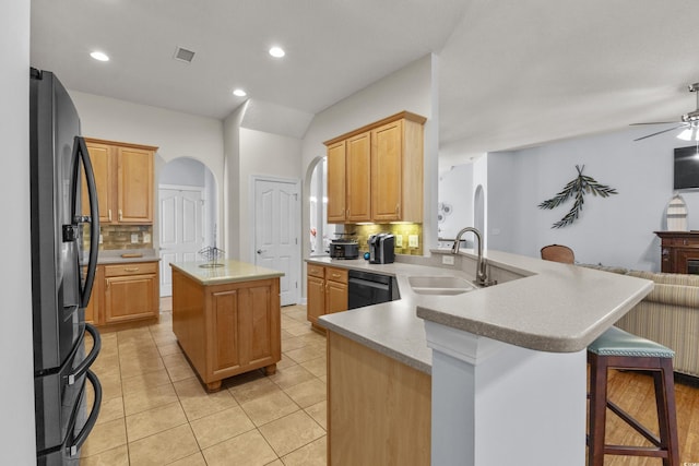 29 Saltwind Loop, Murrells Inlet, SC 29576 - kitchen with black appliances, a sink, arched walkways, tasteful backsplash, and a peninsula