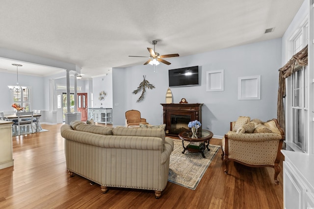 29 Saltwind Loop, Murrells Inlet, SC 29576 - living room featuring a glass covered fireplace, wood finished floors, a ceiling fan, a chandelier, and baseboards