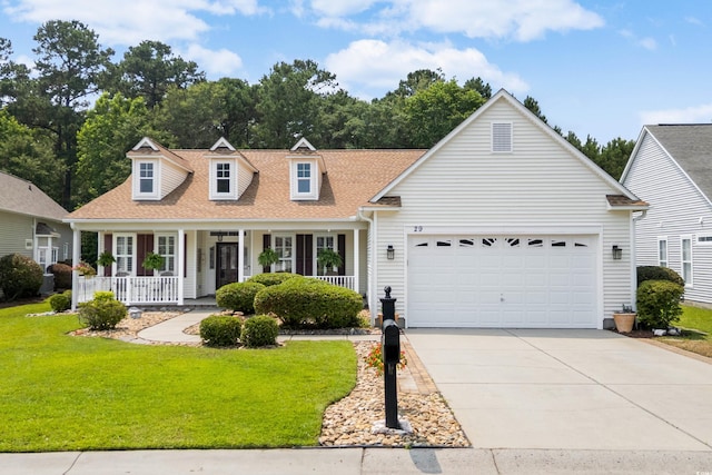 29 Saltwind Loop, Murrells Inlet, SC 29576 - cape cod house featuring an attached garage, driveway, a front yard, and a porch