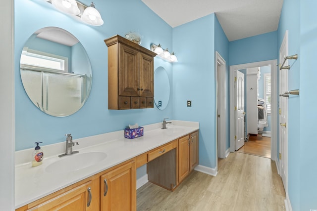 29 Saltwind Loop, Murrells Inlet, SC 29576 - bathroom featuring wood finished floors, double vanity, and baseboards