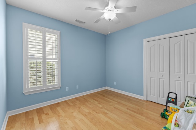 29 Saltwind Loop, Murrells Inlet, SC 29576 - unfurnished bedroom with wood finished floors, a closet, baseboards, and ceiling fan