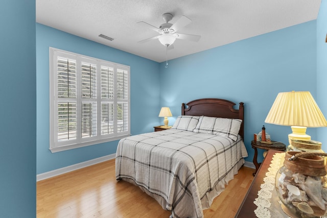 29 Saltwind Loop, Murrells Inlet, SC 29576 - bedroom featuring multiple windows, wood finished floors, baseboards, and a textured ceiling