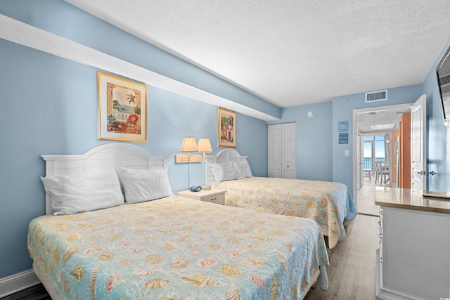 2801 S Ocean Blvd Unit 835, North Myrtle Beach, SC 29582 - bedroom with wood finished floors and a textured ceiling
