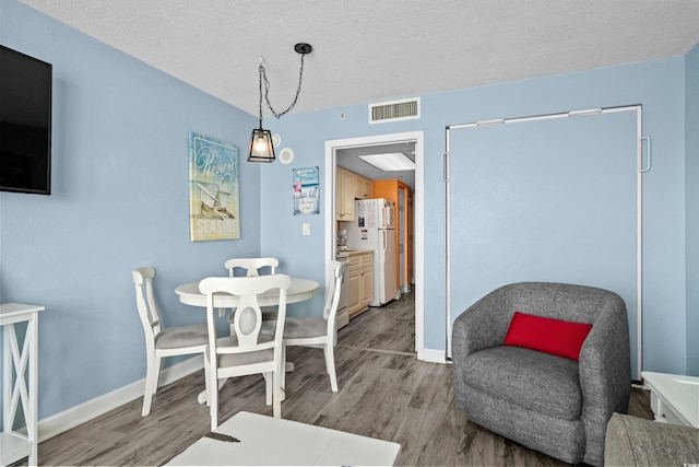 2801 S Ocean Blvd Unit 835, North Myrtle Beach, SC 29582 - dining room featuring wood finished floors and a textured ceiling