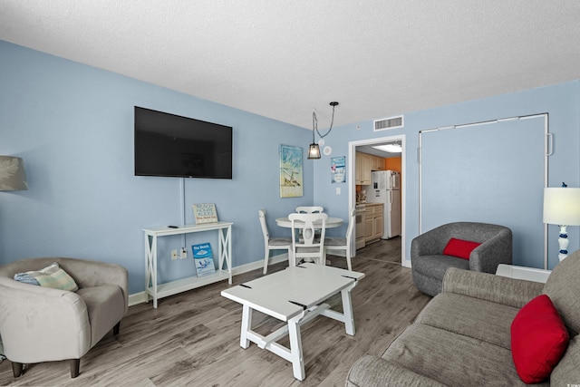 2801 S Ocean Blvd Unit 835, North Myrtle Beach, SC 29582 - living room with wood finished floors and a textured ceiling