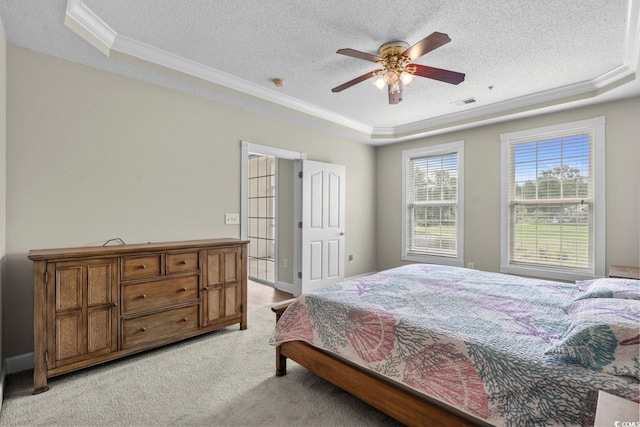 2241 Waterview Dr Unit 514, North Myrtle Beach, SC 29582 - bedroom featuring a tray ceiling, ornamental molding, a textured ceiling, light carpet, and ceiling fan