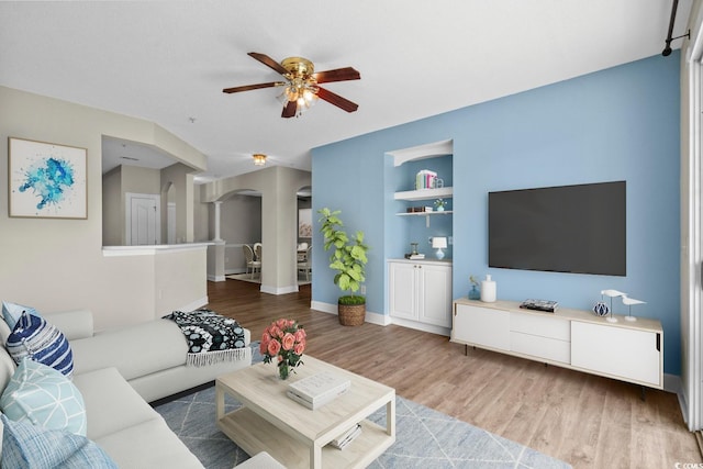 2241 Waterview Dr Unit 514, North Myrtle Beach, SC 29582 - living area featuring arched walkways, wood finished floors, ceiling fan, built in features, and baseboards
