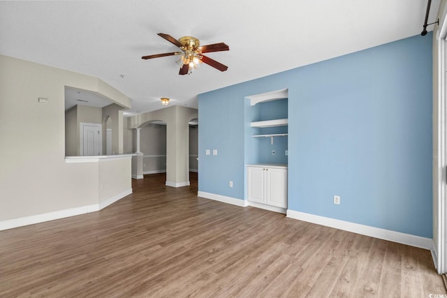 2241 Waterview Dr Unit 514, North Myrtle Beach, SC 29582 - unfurnished living room featuring a ceiling fan, arched walkways, wood finished floors, and baseboards