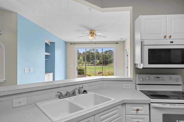 2241 Waterview Dr Unit 514, North Myrtle Beach, SC 29582 - kitchen featuring white appliances, a sink, light countertops, ceiling fan, and white cabinets