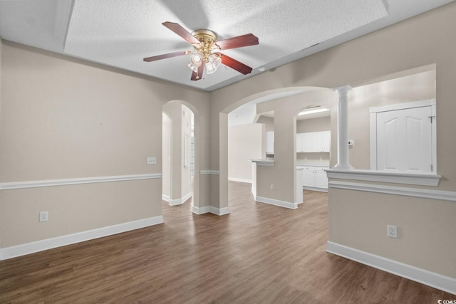 2241 Waterview Dr Unit 514, North Myrtle Beach, SC 29582 - spare room featuring ceiling fan, arched walkways, wood finished floors, baseboards, and a textured ceiling