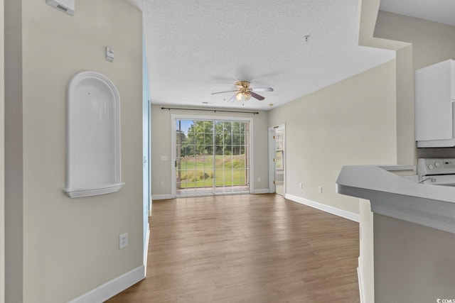 2241 Waterview Dr Unit 514, North Myrtle Beach, SC 29582 - unfurnished living room featuring ceiling fan, baseboards, wood finished floors, and a textured ceiling