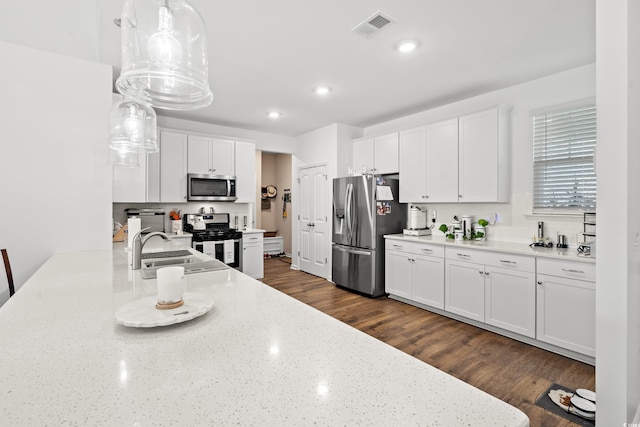 915 Sorano St, Myrtle Beach, SC 29579 - kitchen with stainless steel appliances, a sink, white cabinets, recessed lighting, and light stone counters