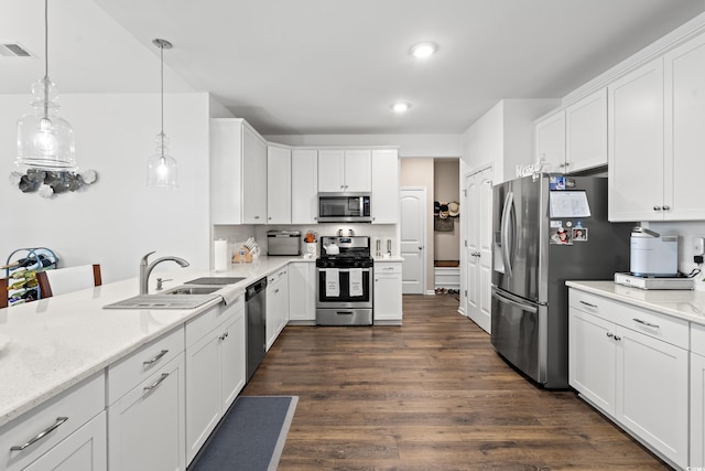 915 Sorano St, Myrtle Beach, SC 29579 - kitchen featuring appliances with stainless steel finishes, a sink, white cabinets, dark wood finished floors, and light stone countertops
