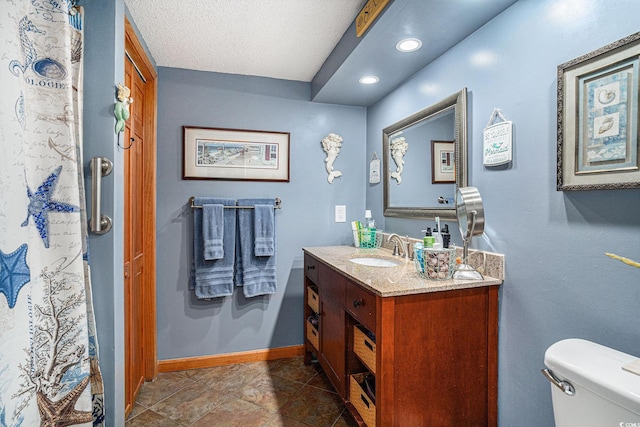 705 11th Ave S, North Myrtle Beach, SC 29582 - full bath featuring vanity, toilet, recessed lighting, baseboards, and a textured ceiling