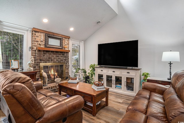 705 11th Ave S, North Myrtle Beach, SC 29582 - living area with a fireplace, light wood-type flooring, recessed lighting, and high vaulted ceiling