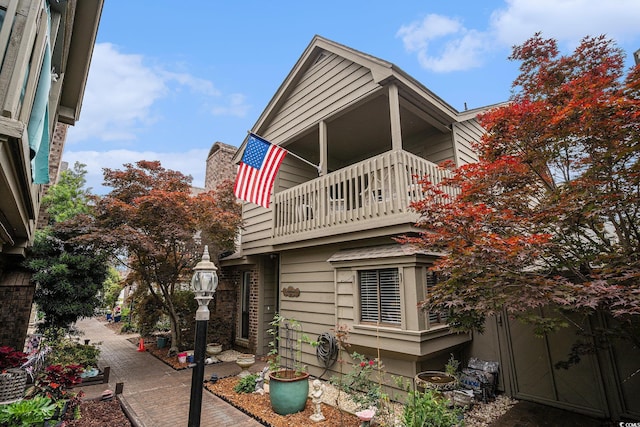 705 11th Ave S, North Myrtle Beach, SC 29582 - view of home's exterior with a balcony and a chimney