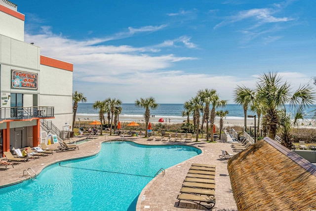 7200 N Ocean Blvd Unit 260, Myrtle Beach, SC 29572 - community pool featuring a patio area, view of water and beach, and stairs