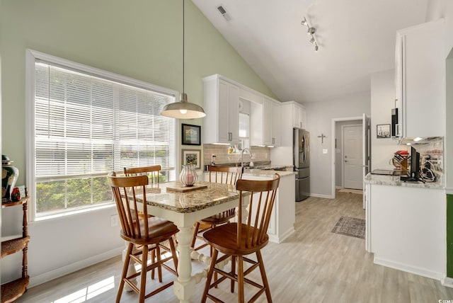 168 Mackinley Cir, Pawleys Island, SC 29585 - dining room featuring light wood finished floors and vaulted ceiling