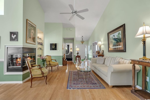 168 Mackinley Cir, Pawleys Island, SC 29585 - living room with high vaulted ceiling, wood finished floors, a multi sided fireplace, and a ceiling fan