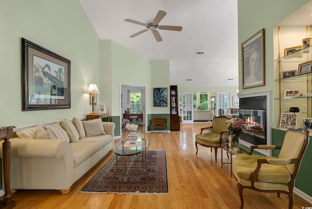 168 Mackinley Cir, Pawleys Island, SC 29585 - living room with high vaulted ceiling, ceiling fan, a multi sided fireplace, and light wood-type flooring