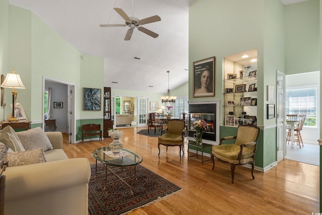 168 Mackinley Cir, Pawleys Island, SC 29585 - living room featuring high vaulted ceiling, plenty of natural light, a ceiling fan, a chandelier, and wood finished floors