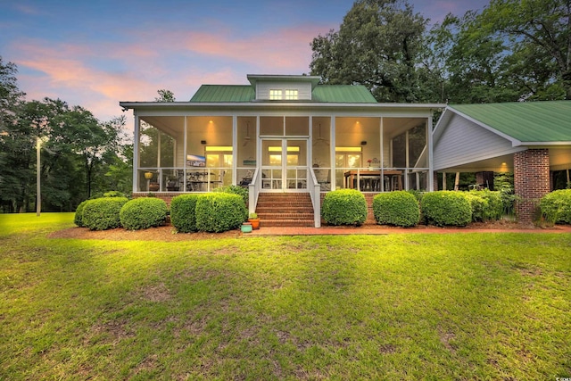 3231 Center Rd, Georgetown, SC 29440 - view of front of property with a sunroom, a lawn, and metal roof