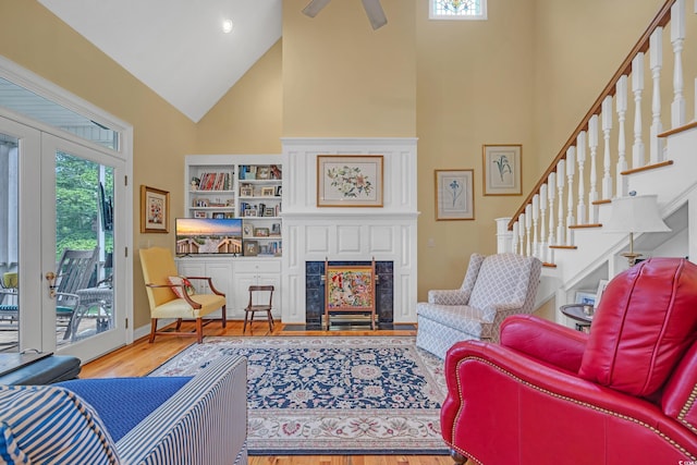 3231 Center Rd, Georgetown, SC 29440 - living room with high vaulted ceiling, wood finished floors, stairs, a fireplace with flush hearth, and ceiling fan