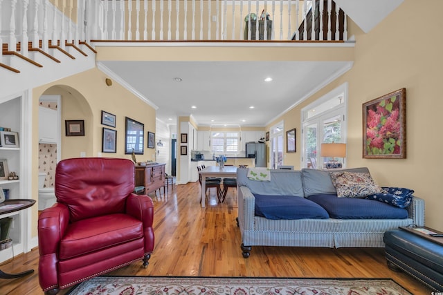 3231 Center Rd, Georgetown, SC 29440 - living room with light wood-type flooring, ornamental molding, arched walkways, recessed lighting, and french doors